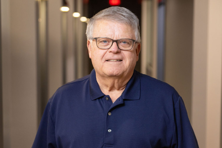 Dr. Steve smiling warmly while standing in a brightly lit hallway at Neville Dental Studio in Horse Cave