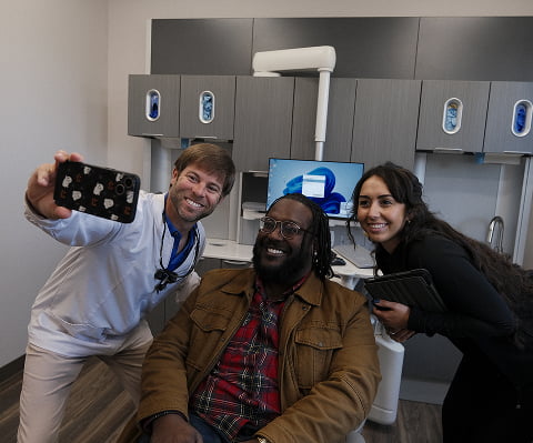 Doctor and assistant taking a selfie with a patient