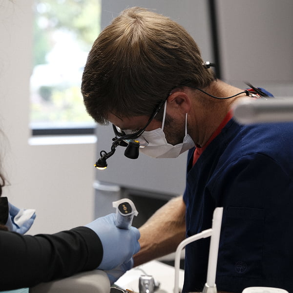 The dentist at Nevile Dental performing surgery